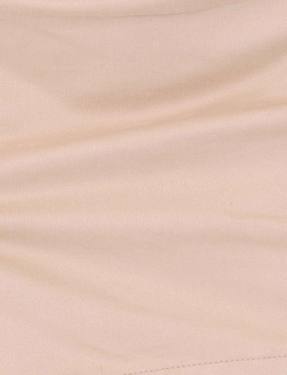 Close-up of the TIGERMIST KITTIE SKORT - TAN showcases its soft fabric, visible stitching, gentle creases, and mini length appeal.