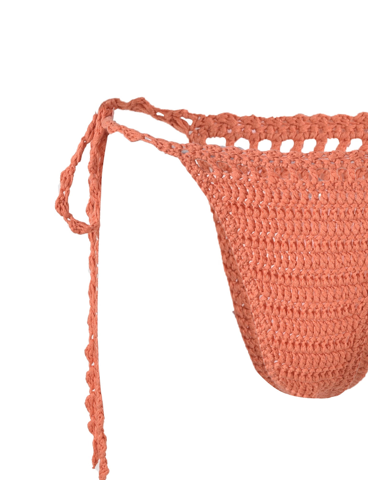 Close-up of the side of the CORA BIKINI BOTTOM - ORANGE by TIGERMIST. The bikini ties at the sides with a thin strap and features a textured knit pattern. The focus is on the details of the knit stitches and the tie closure.