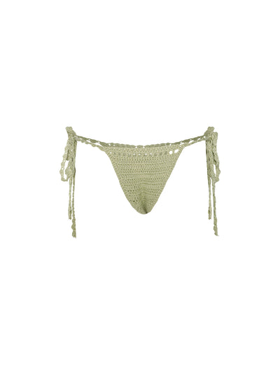 A light pastel green Tiger Mist Crochet Cora Bikini Bottom featuring string ties on both sides. The material showcases a textured, open-knit pattern, with braided strings that add a decorative touch and small tassels at the ends.