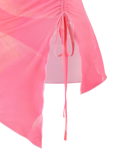 Close-up of the TIGERMIST SARIAH TOP in coral pink and peach, featuring sheer fabric with soft tonal patterns, ruched seam, side slit, and a thin tie detail—perfect to pair with your favorite skirt or bodycon piece.