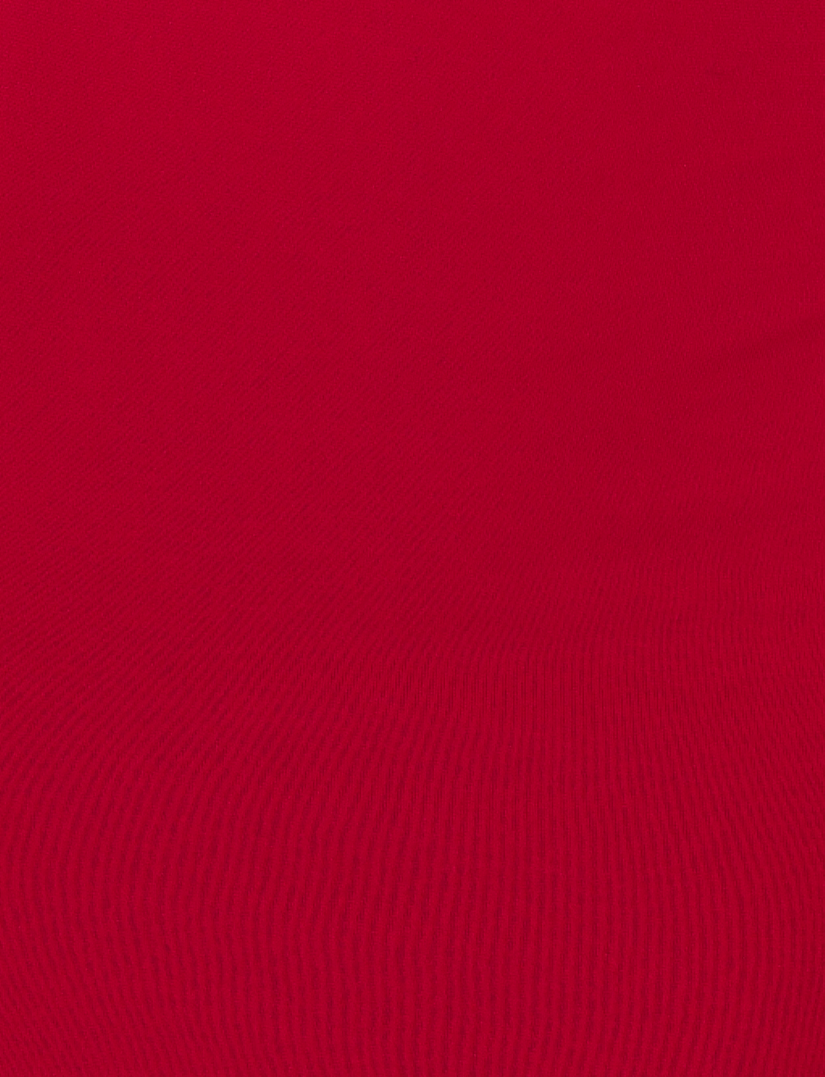 A close-up of the TIGERMIST MORANA MAXI DRESS - RED fabric, highlighting its textured lines and patterns that accentuate the dress's bodycon silhouette.