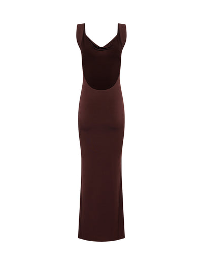 The MORANA DRESS - BROWN : CHOCOLATE by TIGERMIST is a sleeveless, full-length brown dress that boasts a cowl neckline and an open back detail. It features a slim, fitted silhouette with a straight hem extending down to the ankles, crafted from smooth and slightly stretchy fabric.