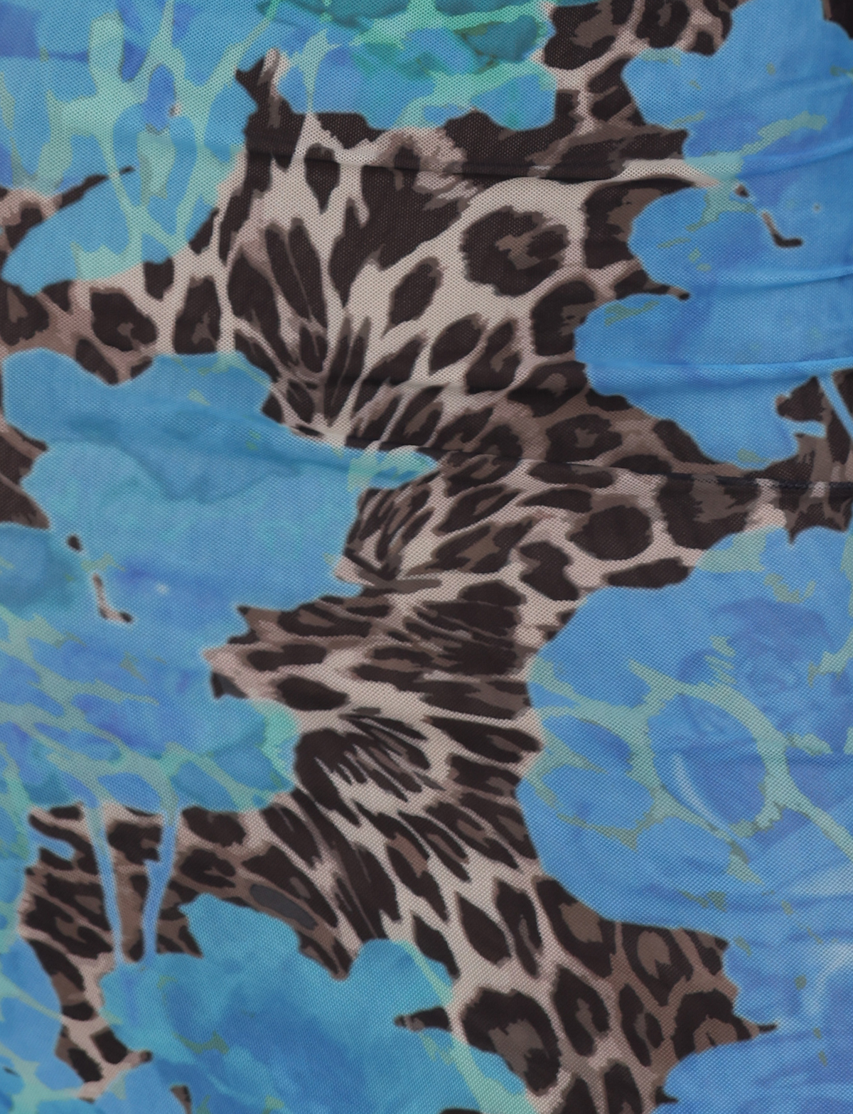 Close-up of the JULIANNA DRESS - BLUE : LEOPARD by TIGERMIST, featuring a vibrant blue floral and leopard print. Ideal for making a statement with this bold, abstract-patterned dress or a striking maxi dress.