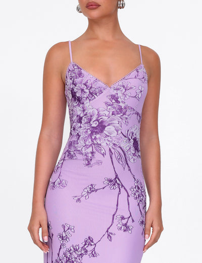 Someone wearing the TIGERMIST JULIANNA DRESS - PURPLE CERAMIC FLORAL with spaghetti straps, showcased against a plain white background.