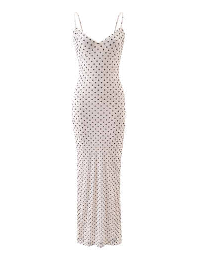 The TIGERMIST JULIANNA MAXI DRESS - POLKA DOT is a long, white maxi dress with a fitted silhouette, adjustable spaghetti straps, and an evenly spaced black and white polka dot pattern.