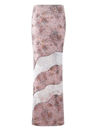 The COLSON SKIRT - PINK : CAMO FLORAL from TIGERMIST is a long, high-waisted skirt showcasing a floral print in muted pink and purple hues. The design includes two white lace inserts that create wavy patterns across the skirt, adding a delicate and elegant touch to its overall feminine style.