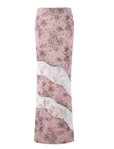 The COLSON SKIRT - PINK: CAMO FLORAL by TIGERMIST features a long, pastel pink design with a beautiful floral print and a wavy white lace band running diagonally across it. The slim, straight silhouette is tailored for a snug fit, perfectly capturing TIGERMIST's chic and modern style.