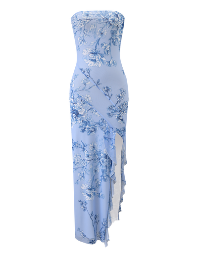 THEO MAXI DRESS by TIGERMIST is a strapless, blue floral mesh bandeau maxi featuring an asymmetrical ruffled hem and a subtle thigh-high split.