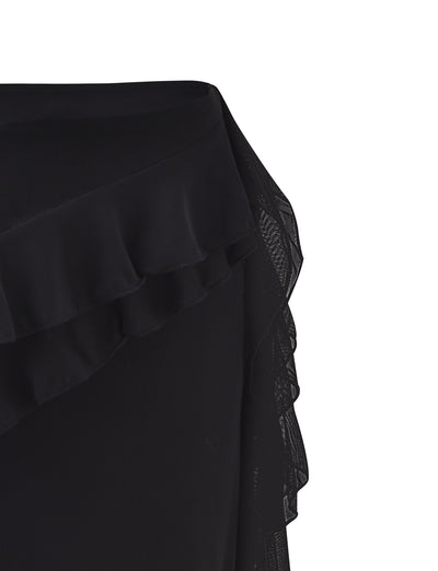 Close-up of the Tiger Mist STORMI SKIRT - BLACK, featuring a layered ruffle detail along the edge. The fabric combines opaque and sheer materials, creating a textured and dynamic look. The ruffle adds a feminine and elegant touch to the design.
