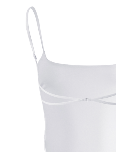 The MINERVA BODYSUIT - WHITE by TIGERMIST is sleeveless with thin spaghetti straps, a diagonal front strap detail, and a flattering bodycon fit.