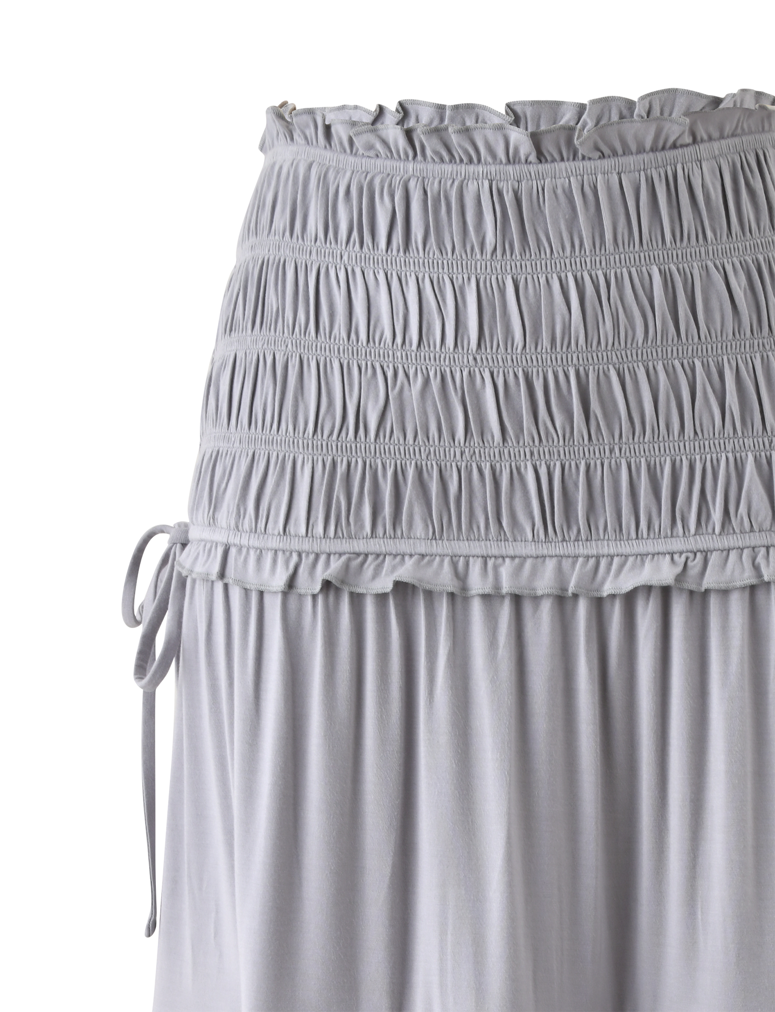 The DENALI MAXI SKIRT - DOVE GREY by TIGERMIST features a smocked, gathered waistband with a decorative left tie, soft modal fabric for a flowy feel, and a ruffled edge at the top for added style.
