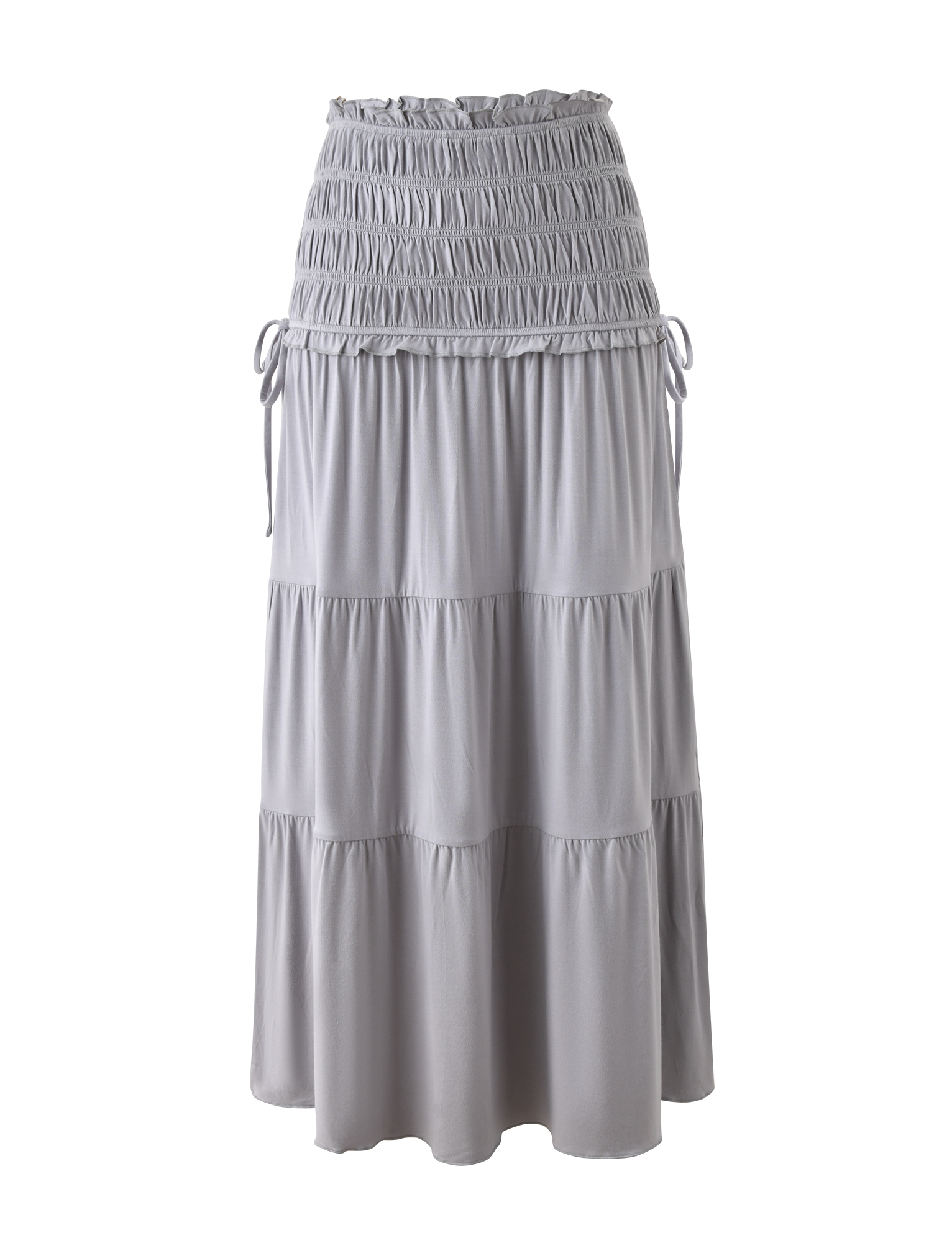 The DENALI MAXI SKIRT - DOVE GREY by TIGERMIST features a light gray, tiered design with a smocked waistband, side drawstring ties, and flowy ruffles. Made from breezy modal fabric, it's shown against a plain white background.