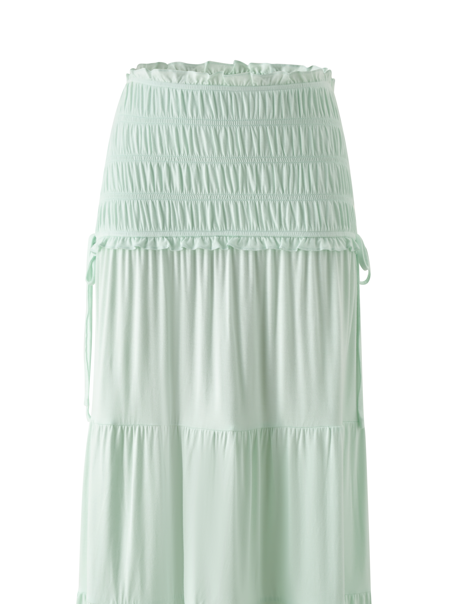 The DENALI MAXI SKIRT in Soft Mint by TIGERMIST features a shirred elastic waistband, tiered flowy design, soft modal fabric for a relaxed fit, and decorative side ties.