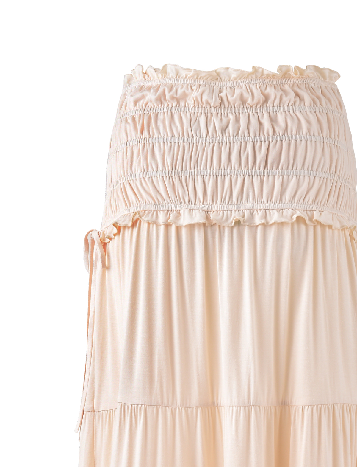 The DENALI MAXI SKIRT - NEUTRAL: BONE by TIGERMIST is a light beige, high-waisted maxi skirt with a ruched, elastic waistband and tiered, flowing design in soft jersey. The flared silhouette appears slightly sheer at the top.