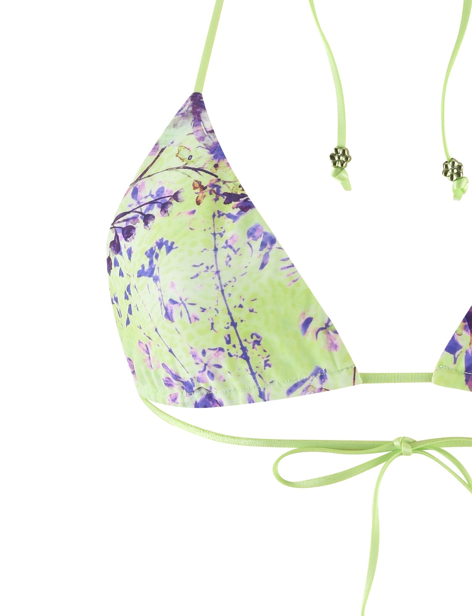 A detailed close-up of the AVE BIKINI TOP - GREEN by POPPY FLORAL from TIGERMIST, featuring a green base with a purple floral pattern. The bikini top has triangular cups and lime-green string ties embellished with decorative beads, which are tied into a bow at the bottom center.