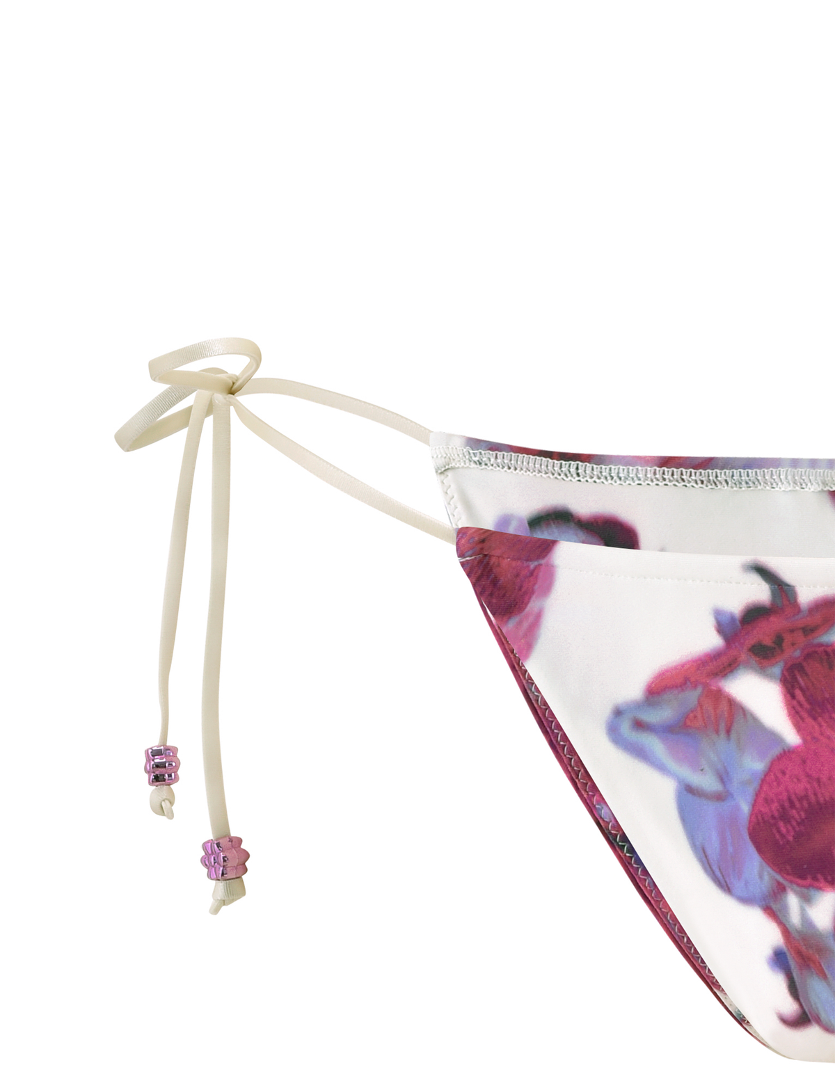 Close-up of the TIGERMIST AVE BIKINI BOTTOM - ORCHID HAZE, a cheeky cut style with red and purple orchid haze print on white, featuring cream side ties finished with two pink beads.