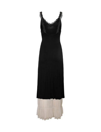 The KACIE DRESS - BLACK from TIGERMIST is a stylish black sleeveless dress with lace-trimmed straps and an empire waist. It features a white layered hem at the bottom, adorned with multiple delicate pleats that create a flowing and elegant design. This dress perfectly blends simplicity with a touch of sophistication.
