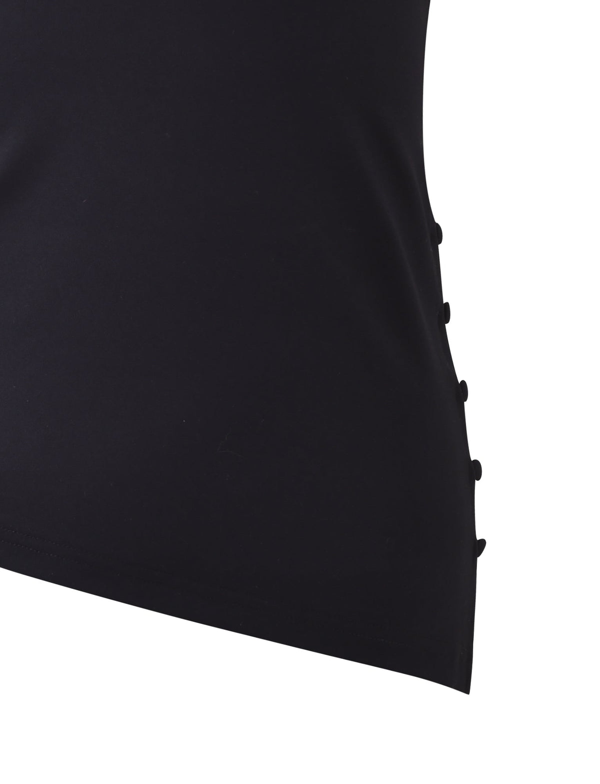 A close-up view of the INDIRA TOP - BLACK by TIGERMIST showcases a series of black buttons running vertically along the side seam. The fabric appears smooth and slightly stretchy, contributing to a simple and elegant design.