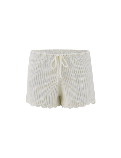 The RIKI SHORT - WHITE by TIGERMIST features an elastic waistband with a front drawstring tie, ribbed knit texture, and scalloped edges at the hem.