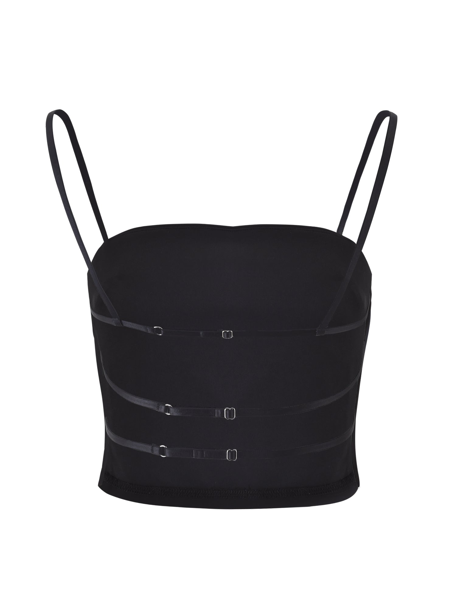 The NAYSHA TOP - BLACK from TIGERMIST is a black cropped top featuring thin spaghetti straps and a straight neckline. The design includes three horizontal straps across the front with small, adjustable buckles, giving it a sleek, minimalist aesthetic.