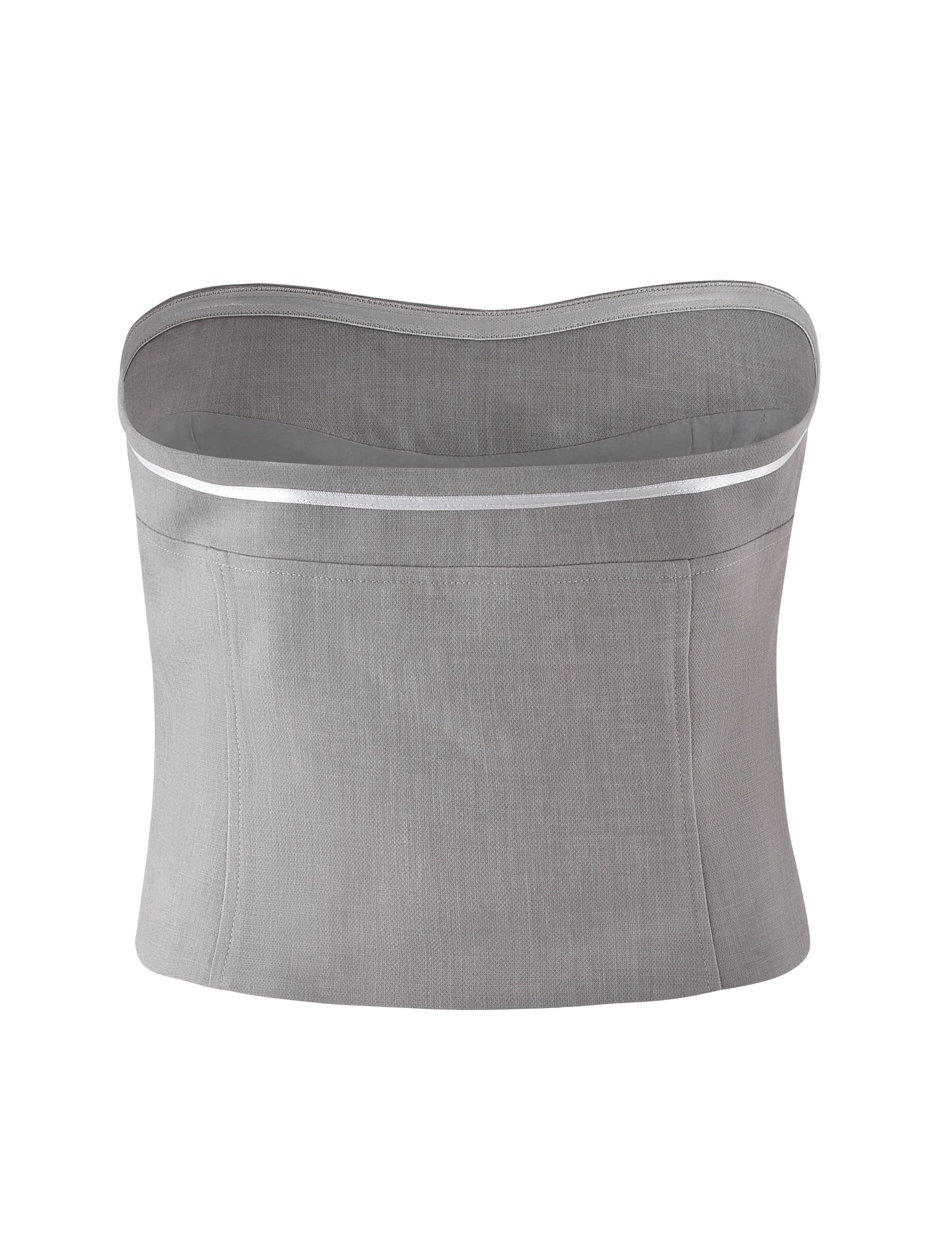 The LENINA TOP - GREY : LIGHT GREY by TIGERMIST is a gray fabric corset with a curved top edge and seamless design. It features horizontal stitching and a subtle reflective strip along the upper edge, providing a modern and minimalistic appearance.