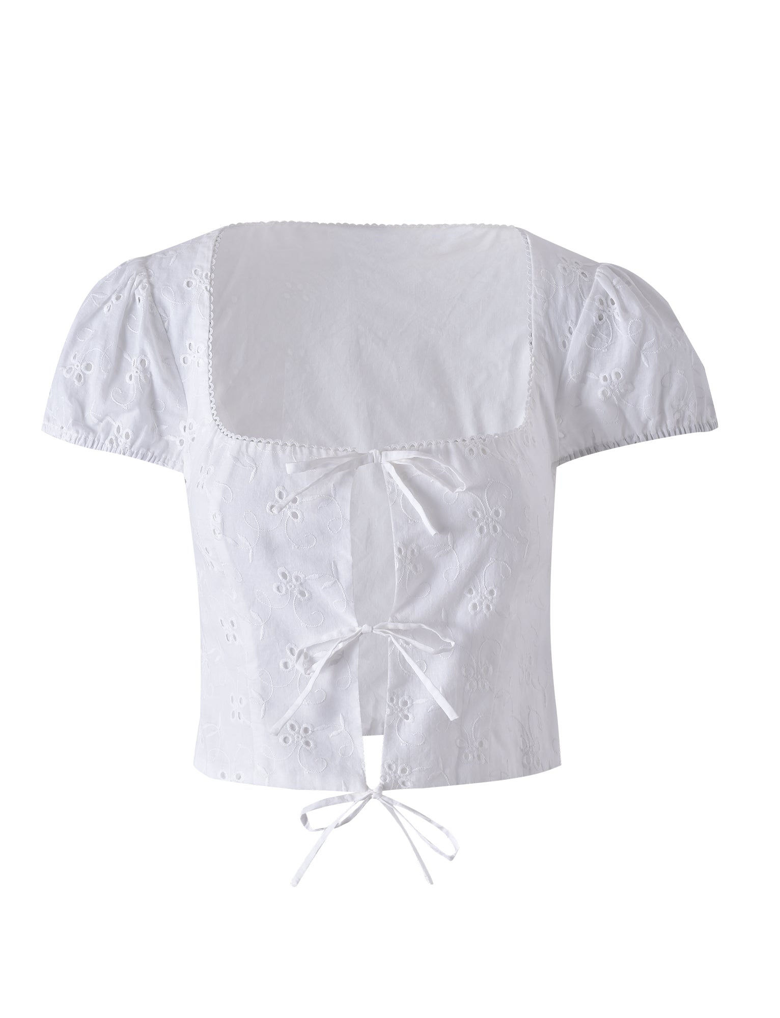 The TIGERMIST Kayleigh Top in white features a square neckline, short sleeves, and eyelet embroidery. It includes three center-front tie closures and showcases a delicate floral pattern on the fabric. This slightly cropped blouse effortlessly blends elegance with a touch of playful charm.