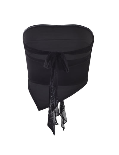 The HARPER TOP - BLACK by TIGERMIST is a stylish black strapless bustier made with semi-sheer fabric and adorned with ribbon details. Featuring a lace tied bow at the back, this piece combines elegance with a sophisticated and modern design.