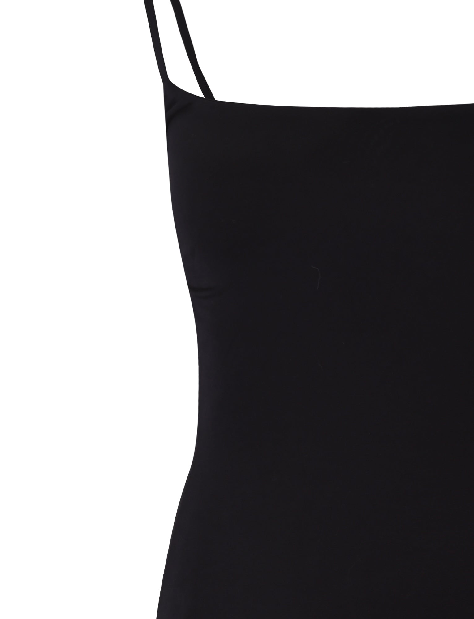 Image showing a close-up of the TIGERMIST MINERVA DRESS - BLACK. The focus is on the upper part of the garment, emphasizing the sleek fabric and simple design with thin spaghetti straps. The white background contrasts beautifully with the black dress.