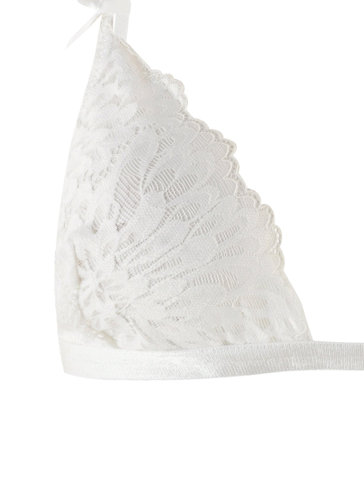 A close-up image of the TIGERMIST BROOKE SET - WHITE bralette reveals intricate sheer lace fabric featuring a floral pattern and scalloped edges, complemented by adjustable shoulder straps. The delicate piece, part of this white lace intimate set, is anchored by a white elastic band at the bottom.