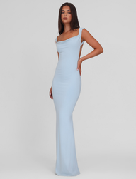 Woman wearing the TIGERMIST ZITA DRESS - BLUE : BABY BLUE, a light blue, floor-length dress with a square neckline and bodycon silhouette, poses against a plain white background.