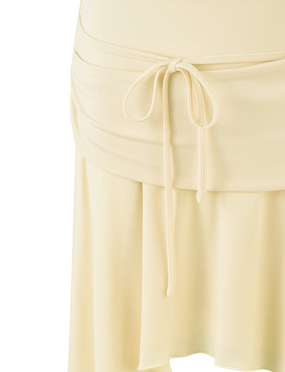 Close-up of the PEARL SKIRT in PALE LEMON by TIGERMIST, featuring a drawstring waistband with tied straps at the front. The skirt has a soft, slightly pleated design, giving it a flowy appearance. The fabric appears to be lightweight and smooth.