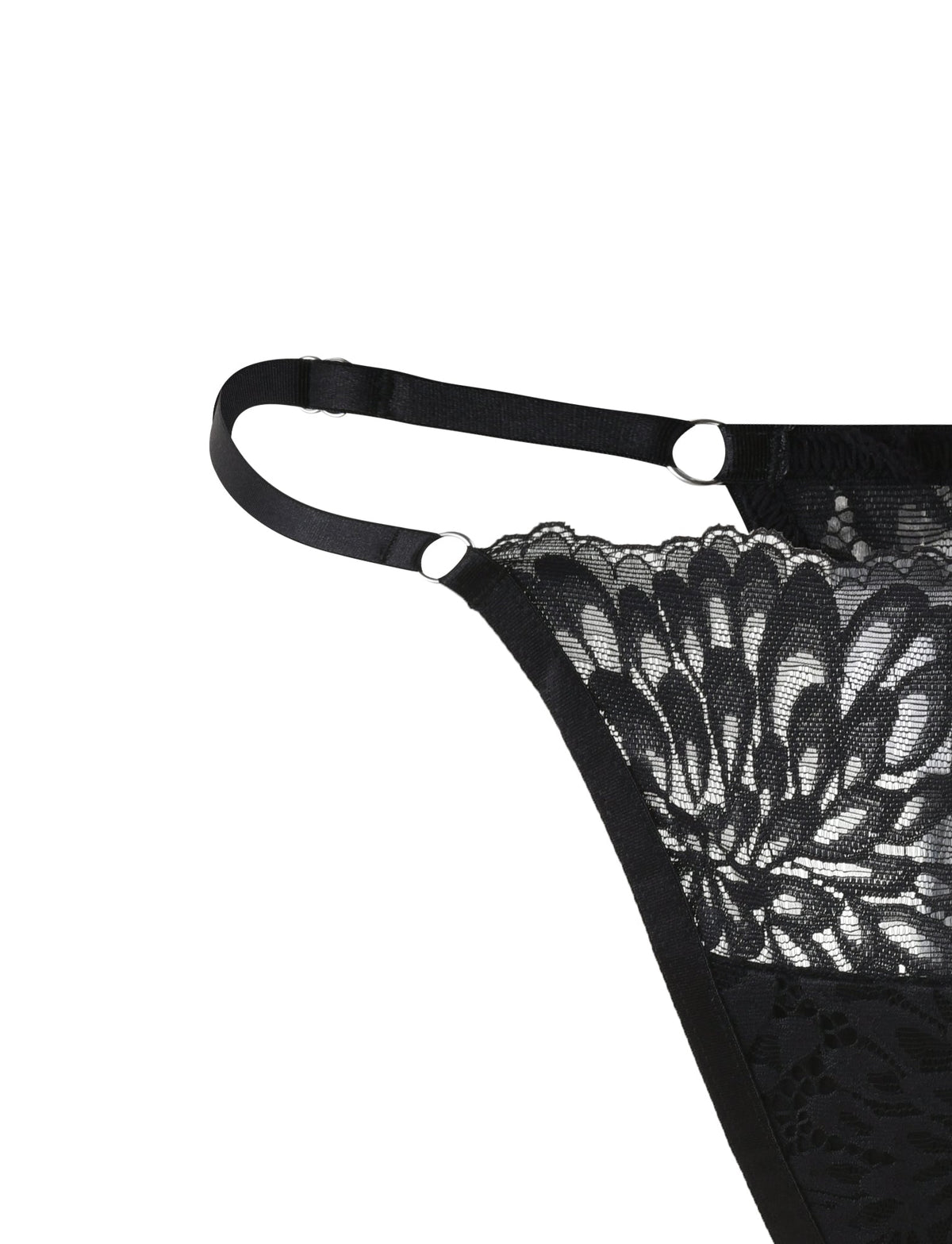 Close-up of the BROOKE SET - BLACK lingerie garment with intricate floral patterns by TIGERMIST. The piece features adjustable straps with metal rings for fastening. The delicate lace details enhance its elegant and sophisticated design.