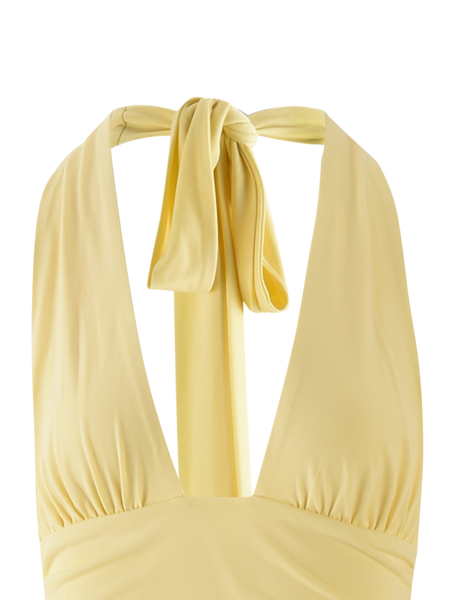 A close-up of the TIGERMIST LENORA DRESS - YELLOW: PALE YELLOW: LEMON, showcasing its halter design with a deep V-neckline and ruched detailing at the bust. The halter ties are knotted at the back of the neck, creating a bow-like appearance. The fabric appears soft and slightly shiny.