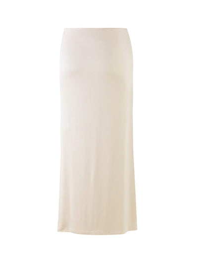 The Karolina Jersey Skirt from TIGERMIST, in a sleek off-white ivory shade, features a long, straight silhouette with a fitted waist and minimal detailing. Its smooth appearance and simple, elegant design fall to ankle-length, making it versatile for various occasions.