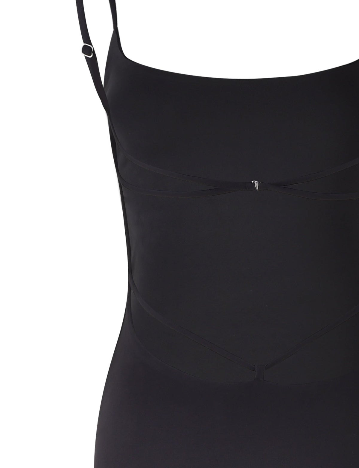 Here's a refined sentence incorporating the product data:

A close-up of the MINERVA MAXI DRESS - BLACK by TIGERMIST, showcasing its sleek sleeveless design with adjustable shoulder straps. The smooth and fitted fabric features subtle overlapping details and is accented by a small, decorative central clasp.
