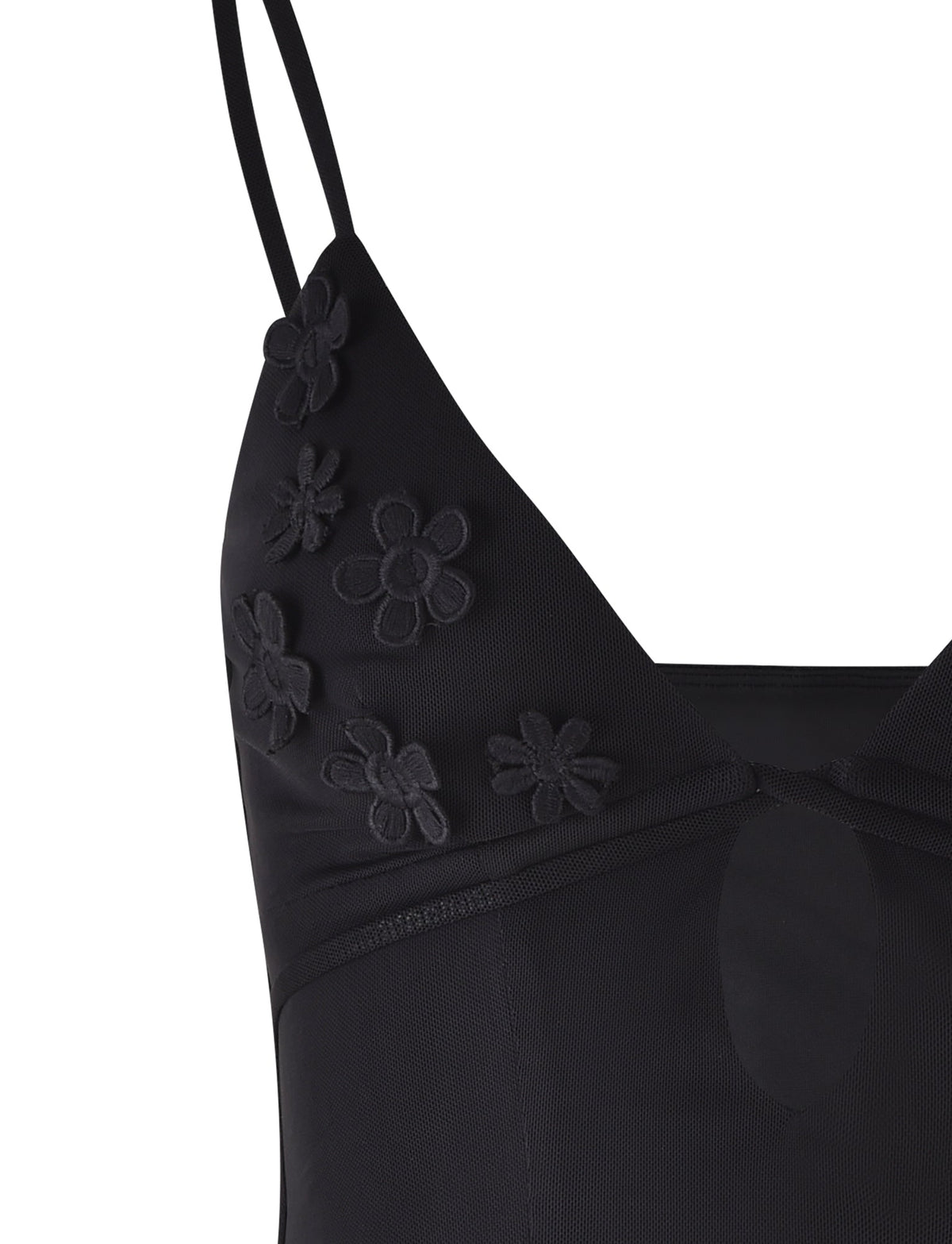 Close-up of the KATINA CAMI - BLACK from TIGERMIST. This black dress features spaghetti straps and delicate, sheer fabric adorned with embroidered flower designs on the bust area. A small keyhole cutout below the neckline adds a charming detail.