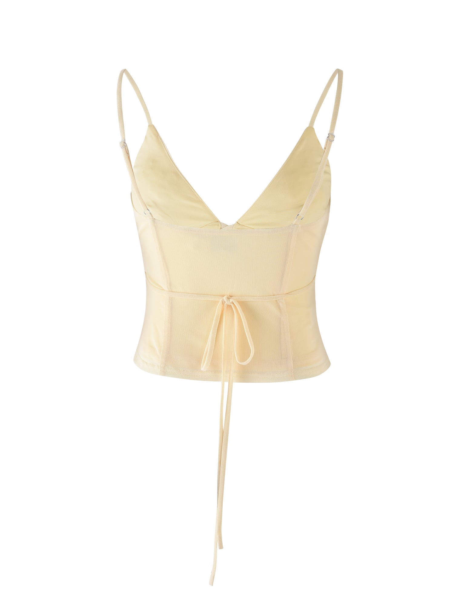 The KATINA CAMI - YELLOW : BUTTER from TIGERMIST is a light yellow, cropped camisole top featuring spaghetti straps and a deep V-neckline. It has a thin, adjustable tie at the waistline for a cinched look, and the material is lightweight and slightly transparent.