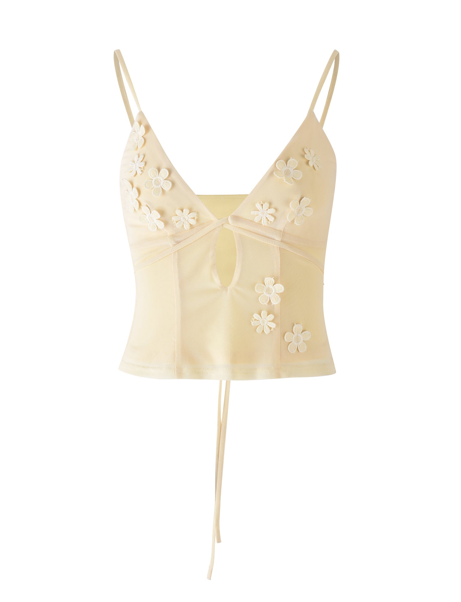 The KATINA CAMI - YELLOW in the Butter shade by TIGERMIST is a beige crop top featuring delicate spaghetti straps and adorned with small white floral appliqués. It has a keyhole cutout at the front and ties at the bottom, made from lightweight, slightly sheer fabric.