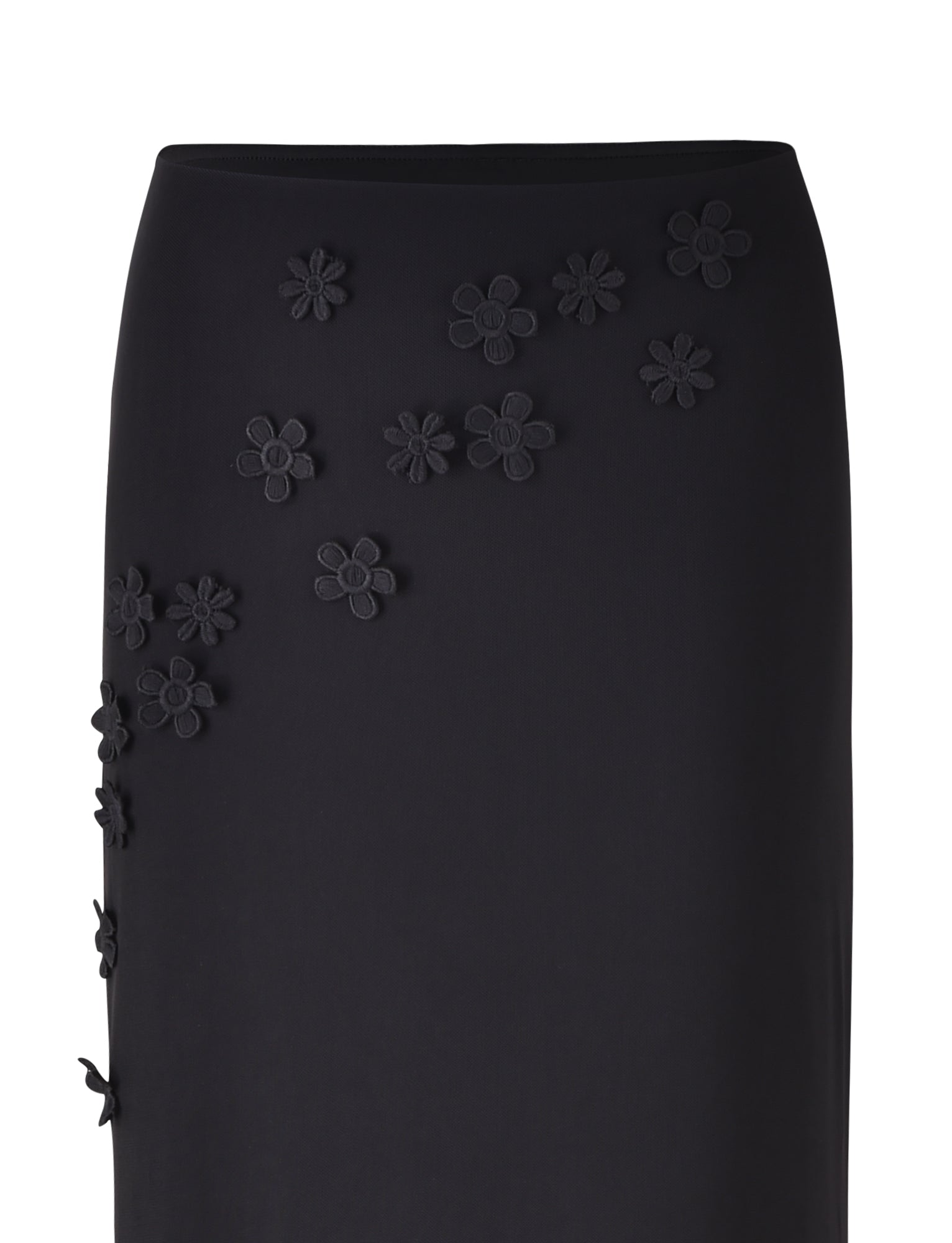 The KATINA SKIRT - BLACK from TIGERMIST features decorative black floral appliqués scattered across the front and side. The three-dimensional flowers add texture to the sleek design of this midi skirt, which is tapered at the waist for a fitted and elegant look.