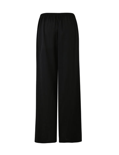 Introducing the LAINEY PANT in BLACK from TIGERMIST: these loose-fitting, long pants feature an elastic waistband and a straight-cut design, offering both relaxation and comfort. Their versatile solid black color makes them suitable for various occasions.
