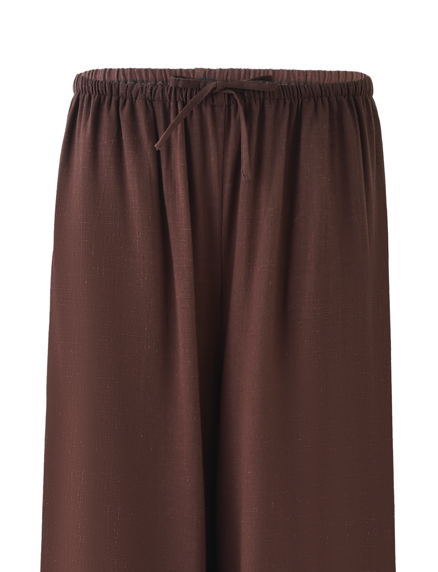 A close-up of TIGERMIST's LAINEY PANT - CHOCOLATE, mid-rise wide leg linen pants with an elastic waistband and front drawstring tie, featuring a subtle textured fabric pattern.