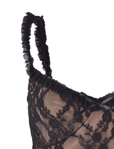 Close-up of the TIGERMIST DEJA Top - Black Lace featuring ruffled straps, an intricate floral lace pattern, and a small satin bow at the center front.