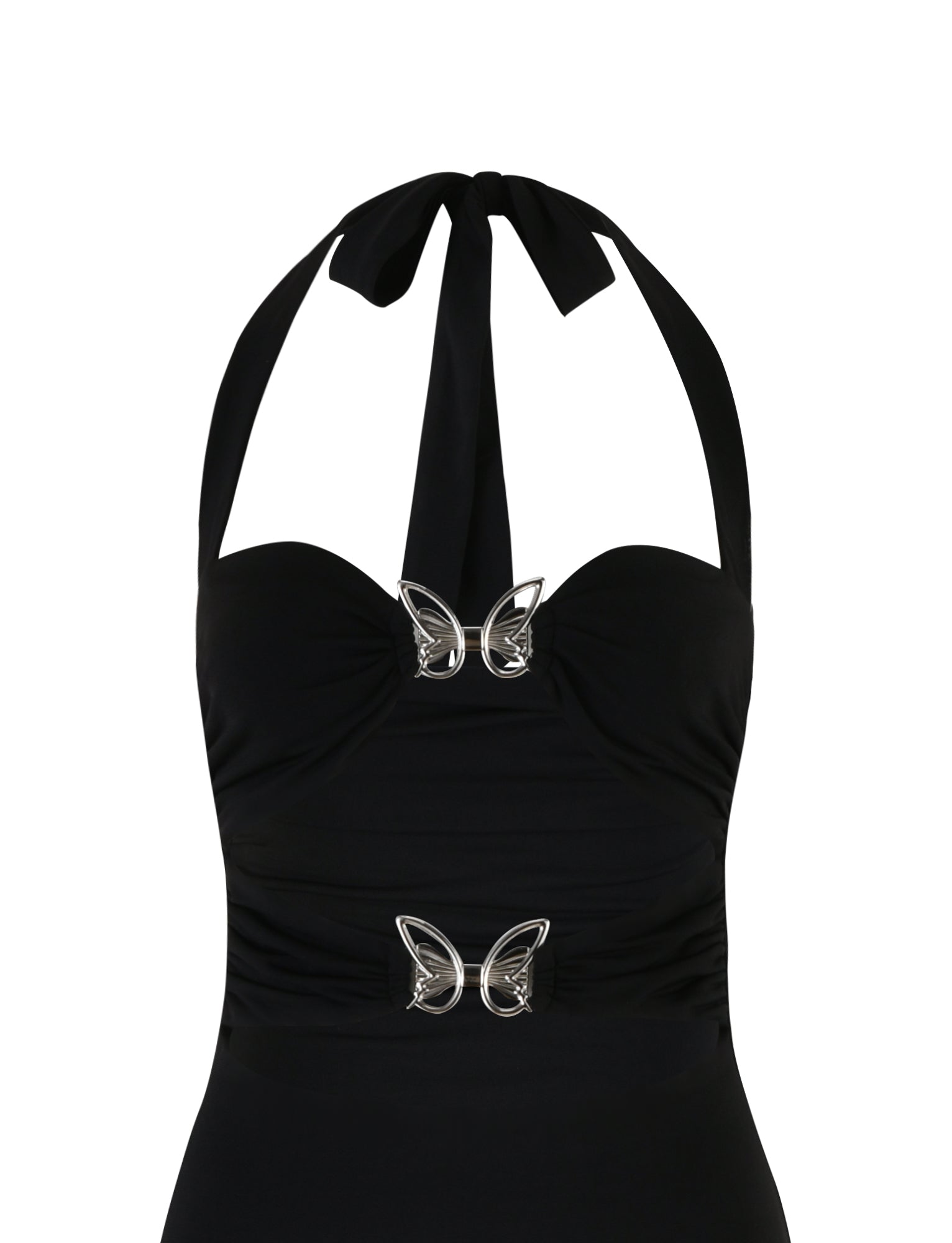 The CORALINE DRESS - BLACK by TIGERMIST is a black halter neck dress featuring two silver butterfly-shaped embellishments, one below the bust and one at the waist. The dress has a gathered front that adds texture and detail to the design, with the halter strap tying at the back of the neck.