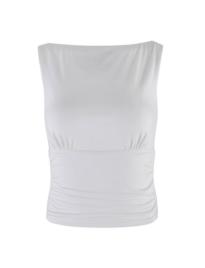 The GWYN TOP - WHITE by TIGERMIST is a sleeveless, fitted blouse featuring a subtle boat neckline and delicate side ruching. Its smooth, slightly stretchy fabric ensures a snug fit around the bust and waist. This simple yet elegant design is perfect for various occasions.