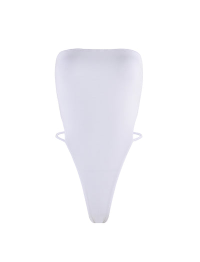 The FINIAN BODYSUIT - WHITE from TIGERMIST is a white, strapless bodysuit with a high-cut leg design. This minimalist piece features smooth fabric for a sleek and seamless look, while two thin side strings provide added support and structure.