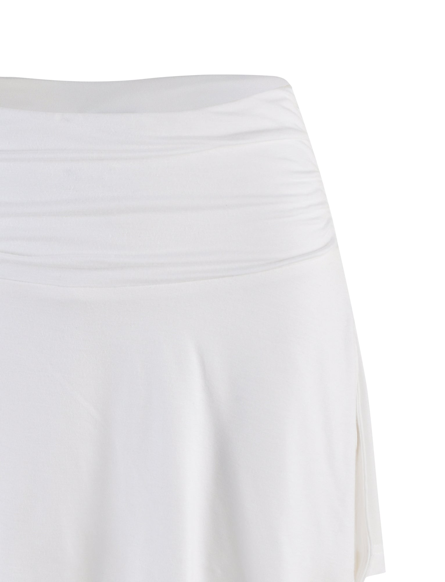 A close-up of the upper section of the TIGERMIST VERITY SKORT in white, featuring a ruched waistband and soft, lightweight fabric, displayed against a plain white background.