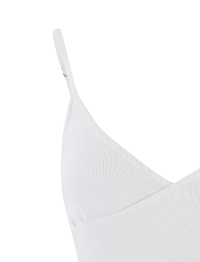 Close-up of the TIGERMIST REY TOP - WHITE camisole with thin straps and a V-shaped neckline. The fabric appears to be ribbed, and the image focuses on the upper left side of the garment, showing part of the shoulder strap and the seam detailing.