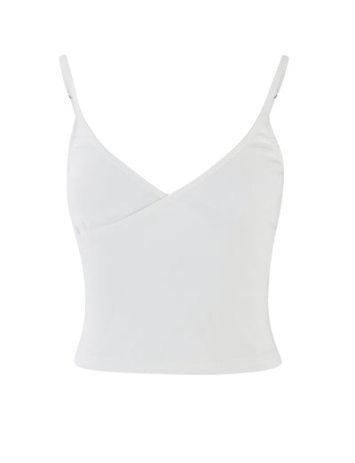 A white REY TOP from TIGERMIST featuring thin adjustable straps and a wrapped V-neckline design. This sleeveless tank top is plain and unadorned, creating a clean and simple look. The fabric appears to be lightweight and slightly stretchy.