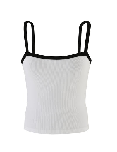 The NIXIE TOP - WHITE from TIGERMIST is a white sleeveless tank top featuring black straps and black edging along the neckline.