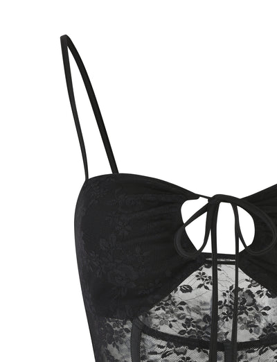 The TOBIAS TOP - BLACK from TIGERMIST is shown. This elegant and delicate lingerie top features thin shoulder straps, a floral lace pattern with sheer sections, and decorative ties at the front.